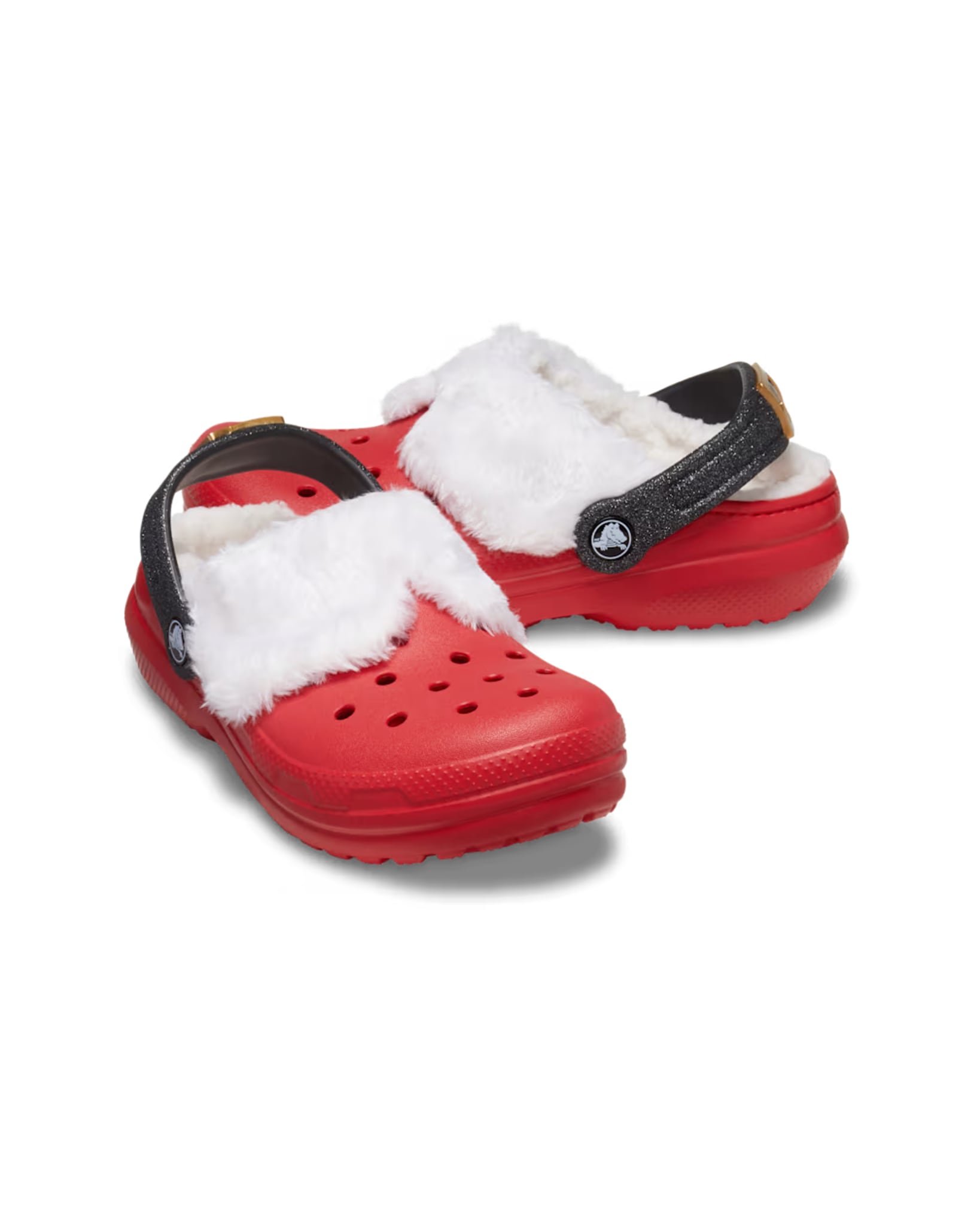 Angled product shot of the Kids Classic Lined Santa Clogs with red uppers, white fluffy lining, and black glitter heel straps.