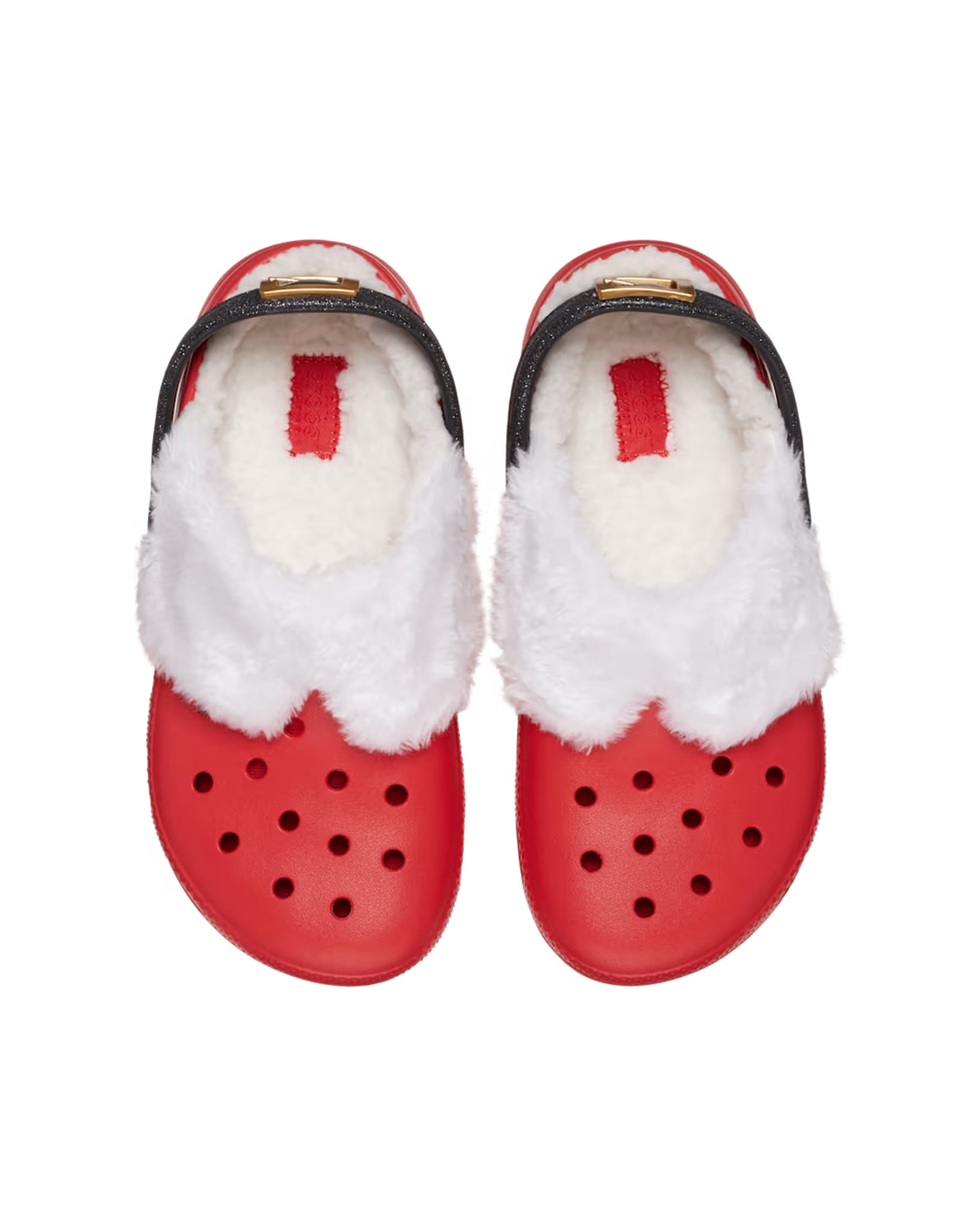 Top view of a pair of Kids Classic Lined Santa Clogs featuring red Croslite™ uppers and plush white fleece lining.